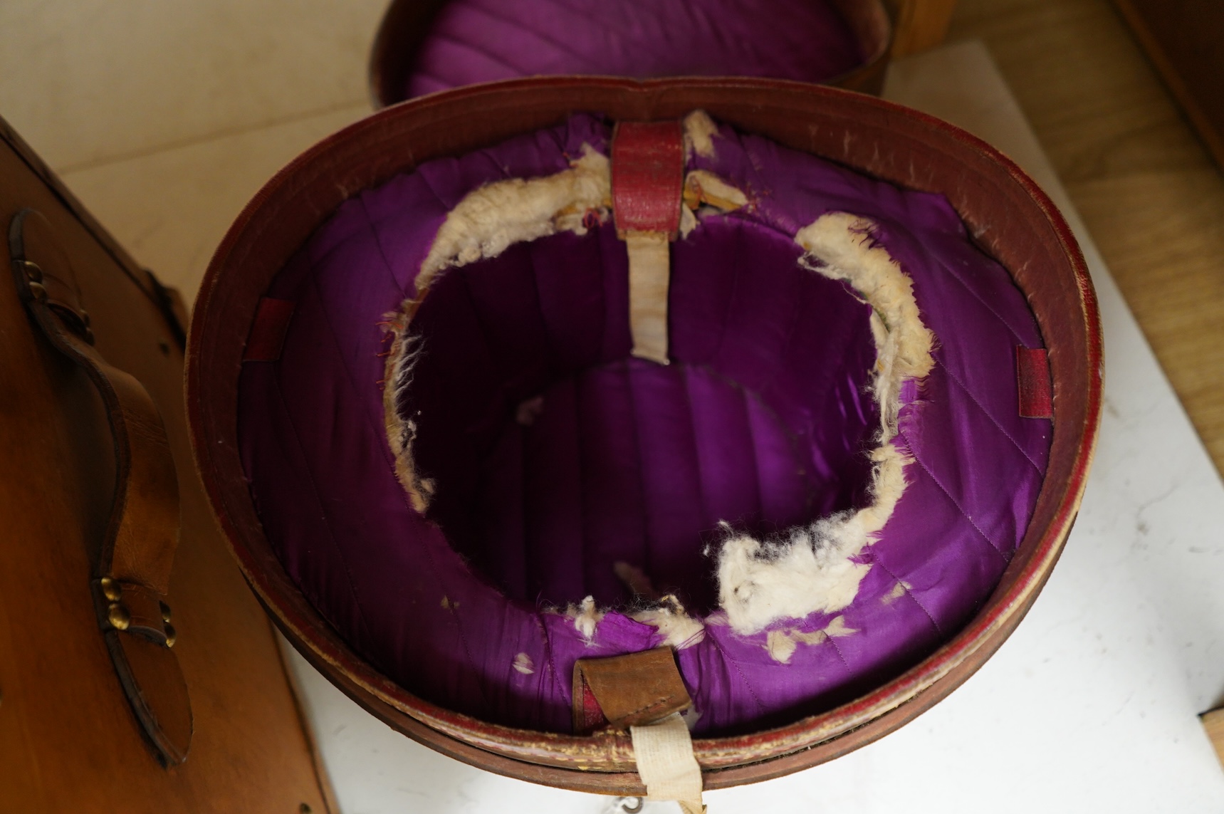 A leather trunk and top hat in box